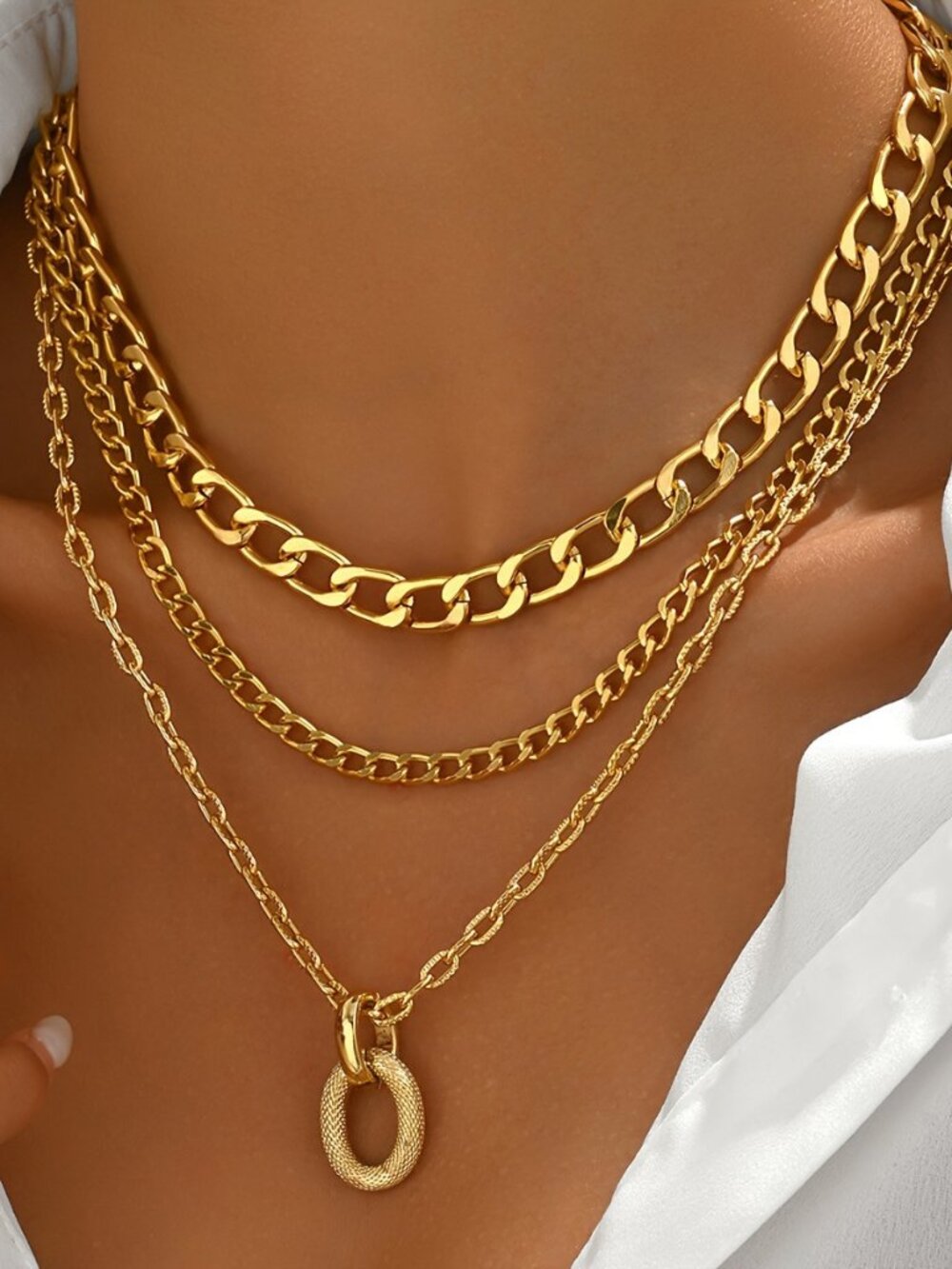 Gold Tone Multi-Layer Chain Necklace with Oval Pendant.
